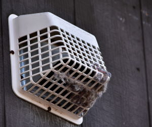 Dirty dryer vent filled with lint and dust.